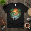 Don't Worry Be Capy T-Shirt with a capybara relaxing in water under palm trees, sunset background