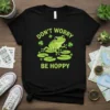 Don't Worry Be Hoppy frog t-shirt design with green text and clovers