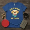Don't Worry Be Yappy text with a smiling dog wearing a bandana on a blue t-shirt