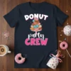 Donut Party Crew text with a stack of colorful donuts on a navy blue t-shirt