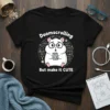 Black t-shirt featuring a cute hamster wearing glasses, holding a phone, with "Doomscrolling But Make it CUTE" text