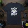 DÖP DOP DOP text design in white with blue bursts and dripping effect, pop art style graphic tee
