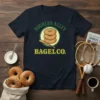 Doubles Alley Bagel Co. t-shirt design featuring stacked bagels and a baseball bat in a circular emblem