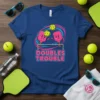 DOUBLES TROUBLE pickleball t-shirt featuring two cartoon pickleball paddles playing at a net