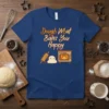 Dough What Bakes You Happy quote on a blue t-shirt with cute graphics of dough, rolling pin, and oven