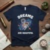 Dreams Are Beautiful t-shirt with astronaut holding dandelion in galaxy, featuring planets and stars, white text