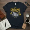 Dreams Don't Work Unless You Do motivational quote t-shirt with rocket, gears, and muscle arm graphics