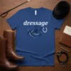 Blue t-shirt with "dressage" text and a graphic of a horse and rider performing a dressage movement with a horseshoe