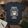 Drink Good Read Books quote on a dark t-shirt, featuring a coffee cup with an open book design and coffee