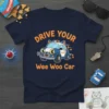 Drive Your Wee Woo Car t-shirt design with a cute cat driving a police car graphic. Features orange text and