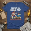 Driving My Husband Crazy One Chicken At A Time t-shirt with cartoon woman holding wrench and husband overwhelmed by chickens