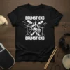 Black t-shirt with white text "DRUMSTICKS DRUMSTICKS" and graphic of crossed drumsticks, cymbals, and drum set