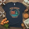 Dutch Heritage Pella IA t-shirt design featuring windmills, Dutch houses, and tulips, with "Pella, IA" text