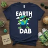 EARTH DAB t-shirt design with a cartoon earth character dabbing, white clouds, and bold text