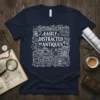 Easily Distracted by Antiques quote on a navy t-shirt, surrounded by detailed illustrations of clocks, books, birdcages, and vintage items