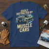 Easily Distracted By Muscle Cars text with a green vintage muscle car graphic on a navy blue t-shirt