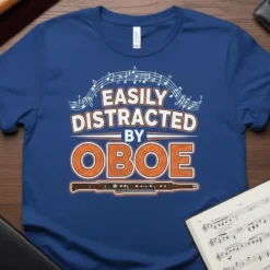 Easily Distracted By Oboe text design with musical notes and an oboe graphic, displayed on a blue t-shirt