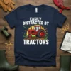 Easily Distracted By Tractors quote on a navy t-shirt with a vintage red tractor graphic and sunburst