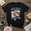 Black t-shirt with "EAST COAST BREAKFAST CLUB" text above a cartoon diner counter with a sandwich and red stools