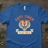 Easy Tiger Play Nice slogan with a roaring tiger graphic on a royal blue t-shirt