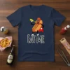 Navy blue t-shirt with "EAT ME" text and a cartoon hot dog character spraying mustard