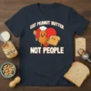 Eat Peanut Butter Not People t-shirt design with a smiling peanut character holding a spoon and a piece of toast