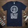 Eat Sleep Collect Repeat T-Shirt design featuring stacked stamps in a circular emblem and white typography