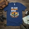 Eat Sleep Shed Hunt Repeat text with a graphic of a hunter and deer antlers on a blue t-shirt