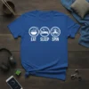 Eat Sleep Spin text with icons for ramen, bed, and fidget spinner on a blue t-shirt