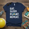 Navy t-shirt with white text "EAT. SLEEP. FLOAT. REPEAT." and a graphic of a person floating on an orange inner
