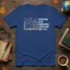 T-shirt with "EDUCATION IS AN ATMOSPHERE, A DISCIPLINE AND A LIFE." quote and an open book graphic with sun and