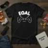 Black t-shirt with white text "Egal" and a line drawing of arms shrugging with question marks above them
