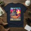 El Squatcho t-shirt design featuring a cowboy-clad Bigfoot with a UFO in a desert landscape, including cacti and a moon