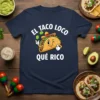 El Taco Loco Qué Rico t-shirt featuring a cartoon taco wearing a sombrero and giving a thumbs up, with text