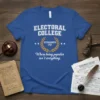 Blue t-shirt with white text "ELECTORAL COLLEGE ESTABLISHED 1787 Where being popular isn't everything." featuring a laurel wreath graphic