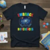 Embrace Differences t-shirt with colorful galaxy and silhouette figures, promoting autism awareness and acceptance