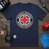Navy blue t-shirt featuring a circular emblem with red cross and "EMERGENCY DEPARTMENT" text, for medical professionals