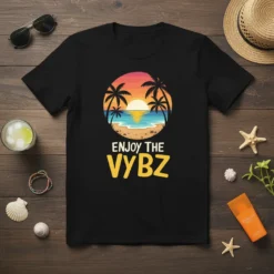 Black t-shirt with "Enjoy The Vybz" text and a tropical sunset beach graphic featuring palm trees and ocean waves