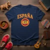 Navy blue t-shirt with "España" in yellow arched text and a circular Spanish coat of arms featuring a lion