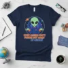 Even Aliens Can't Figure Out What 67 Means t-shirt with a green alien shrugging, surrounded by planets and stars