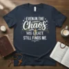 Even In The Chaos His Grace Still Finds Me religious quote t-shirt with a gold cross and stars graphic