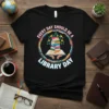 Black t-shirt with "Every Day Should Be A Library Day" quote and a circular design of stacked books and foliage