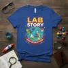 Blue t-shirt with "Lab Story" and "Every Test Tells A Story" text, featuring science graphics like a microscope, rocket, and