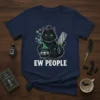 Black cat with green eyes wearing a top hat, holding a cleaver and a cauldron with skulls, text "Ew People"