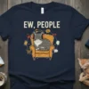 Ew, People t-shirt design featuring a grumpy cat wearing headphones sitting in a chair surrounded by social media icons and