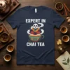 Expert In Chai Tea text with a meditating panda graphic on a navy t-shirt, celebrating tea appreciation