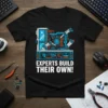 Black t-shirt with "EXPERTS BUILD THEIR OWN!" text and a graphic of a computer build process with robotic arms