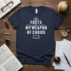 Facts My Weapon of Choice t-shirt featuring white text and book graphic on navy blue fabric