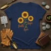 Navy t-shirt with sunflowers and the words "faith hope love" in cursive font, inspirational quote design