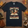 Fall in Love with Learning quote t-shirt with an owl on a book, surrounded by autumn leaves and science icons